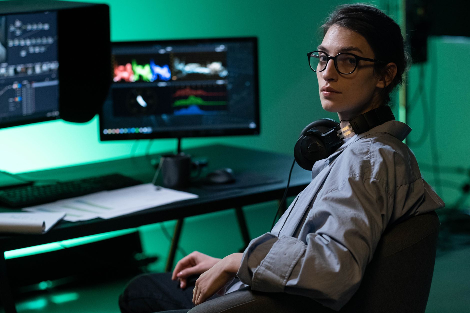 Digital artist adjusting a surreal landscape image on a large monitor